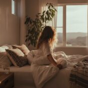 A woman in california considering her options for a mental health relapse treatment as she lies in her messy bed.